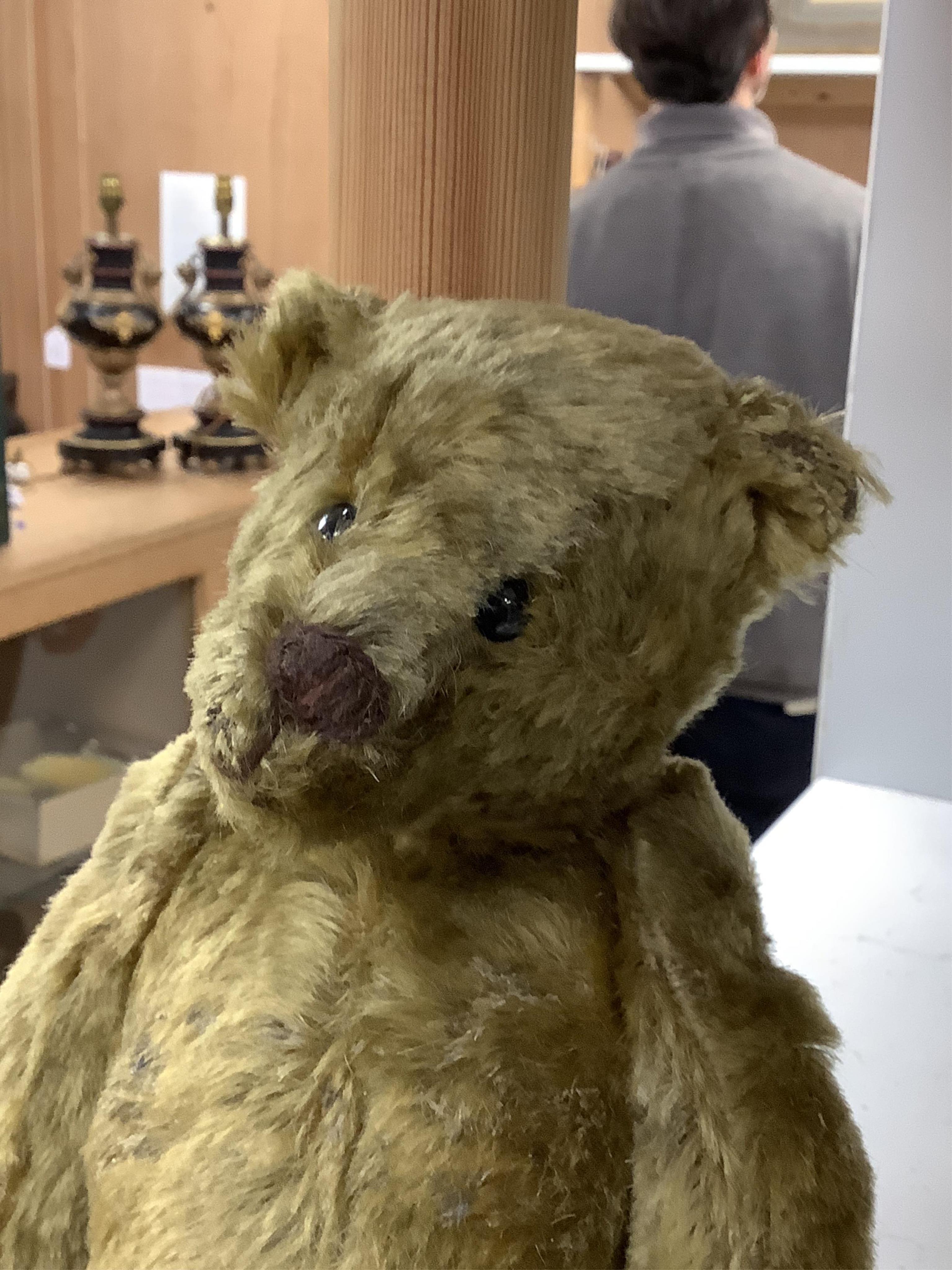 An early 20th century German hump backed plush teddy bear and three others, German teddy 30cm high. Condition - the German teddy has a short split on the back seam and glue on the front leg that needs removing and plush